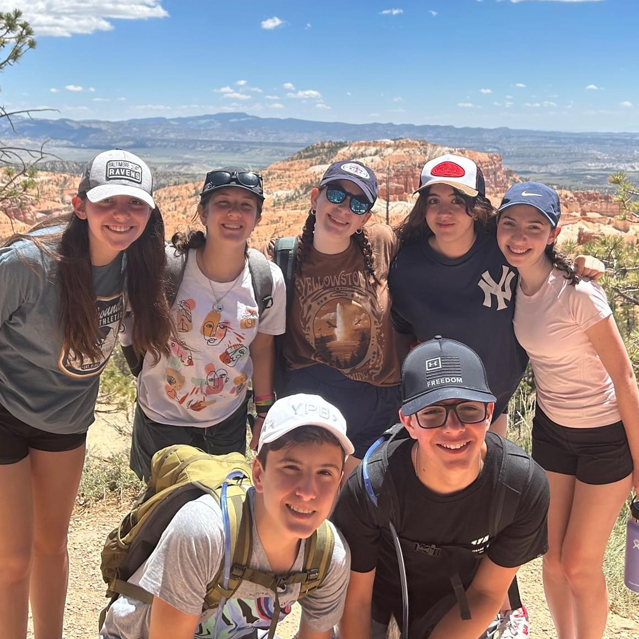 Group shot of teens smiling on a hike in nature in Israel. 